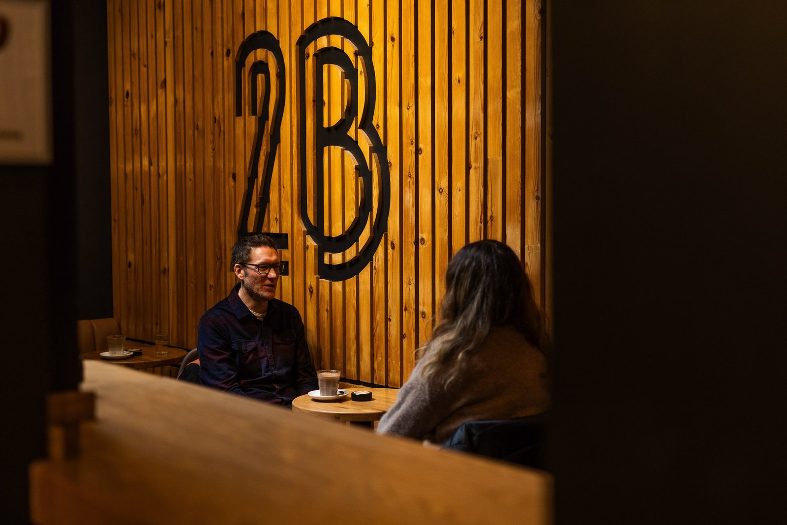 Garry working with a client in a coffee shop